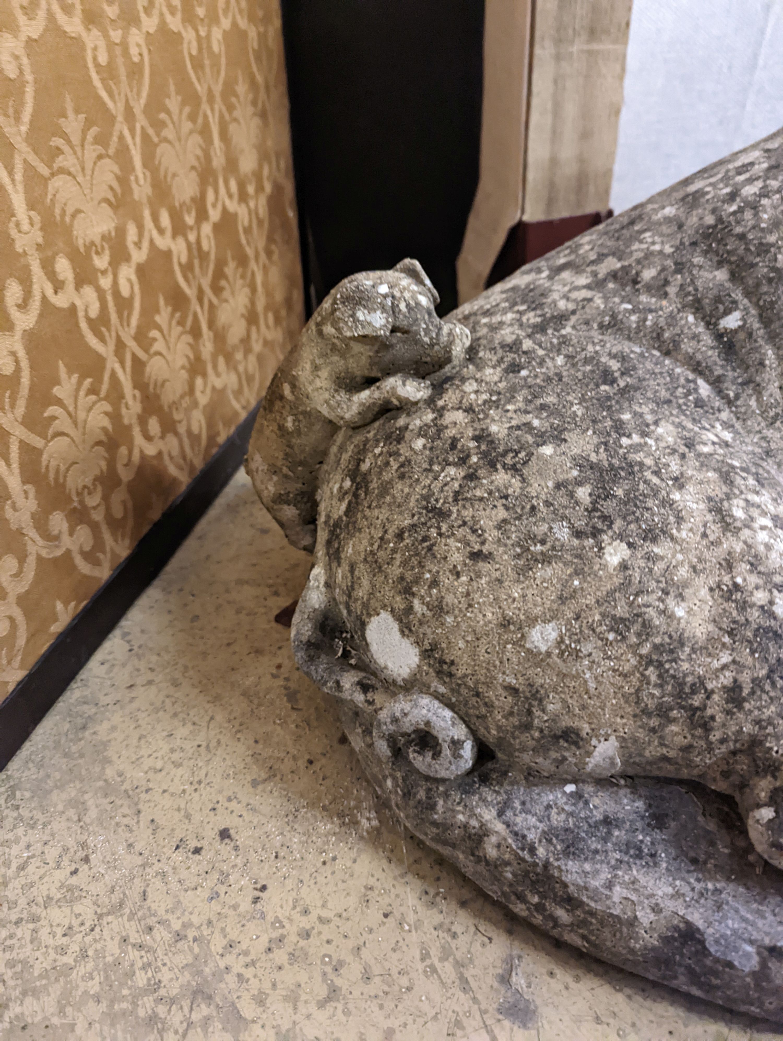 A reconstituted stone garden ornament of a sow with piglets, width 56cm, height 35cm